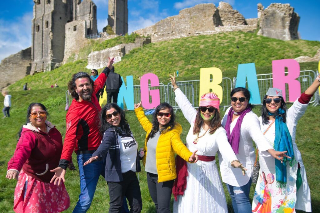 Group of people celebrating Holi at Corfe Castle